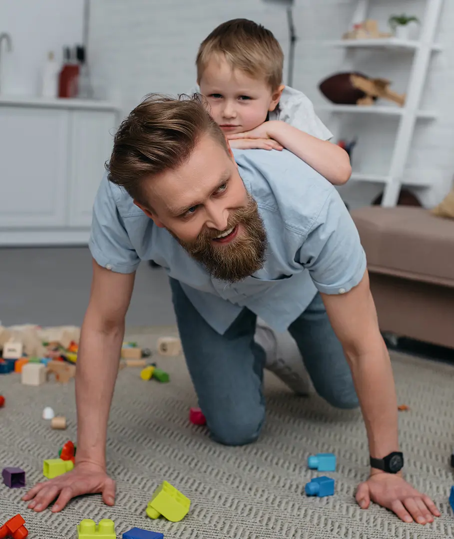 smiling father and little son having fun together at home Infant & Child Injuries
